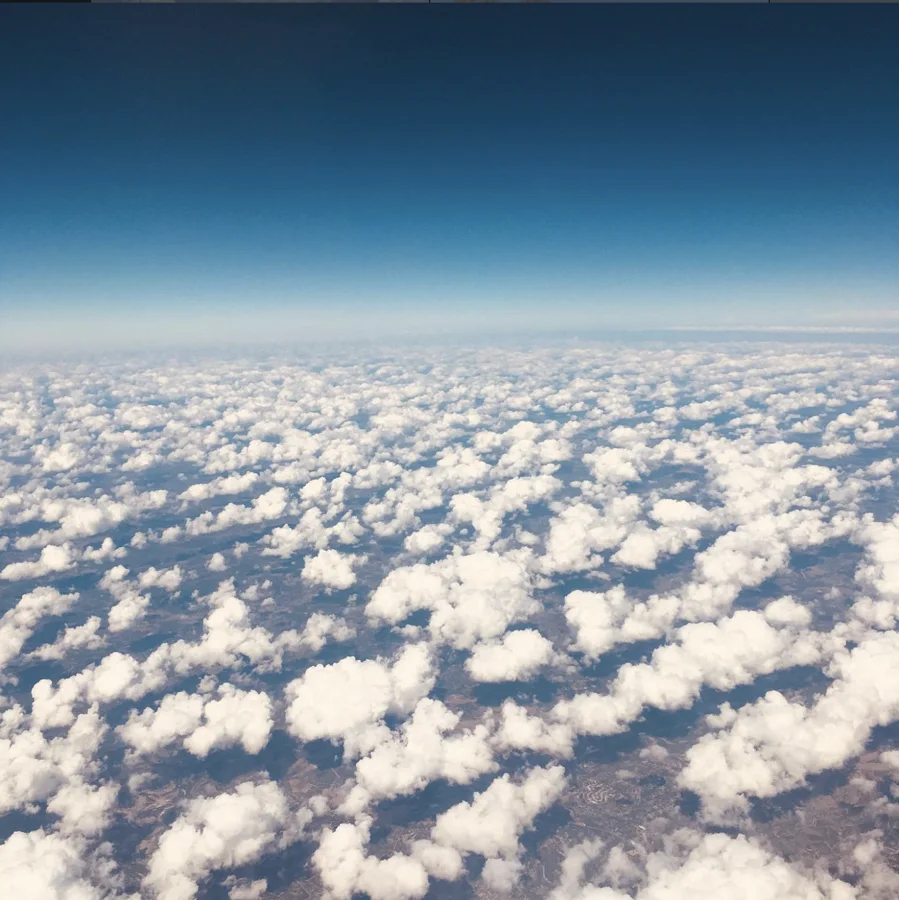 White clouds stretching beneath a deep blue sky