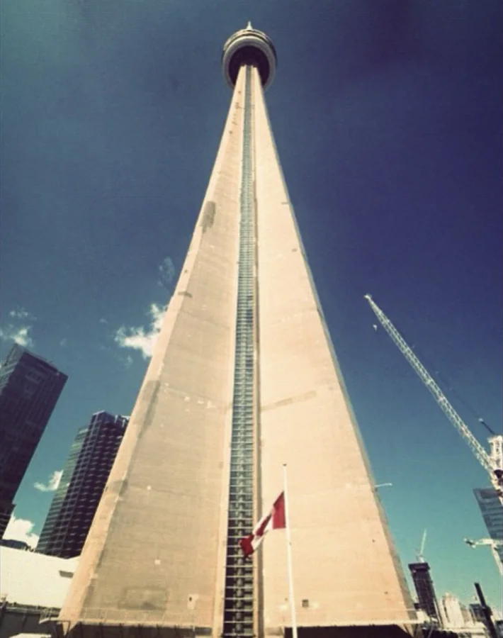 CN Tower viewed from its base against a blue sky