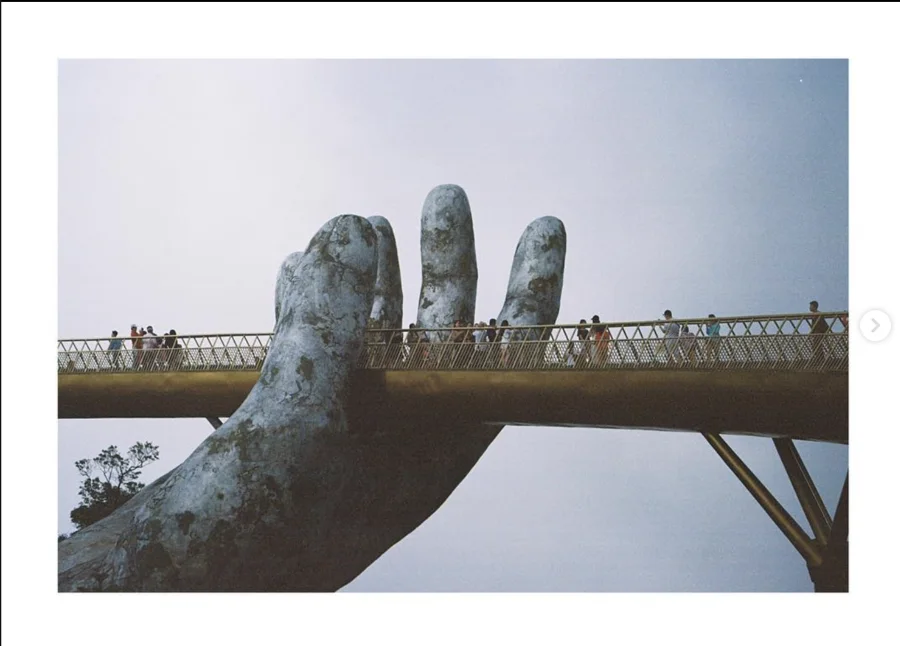 A bridge supported by a giant sculpted stone hand