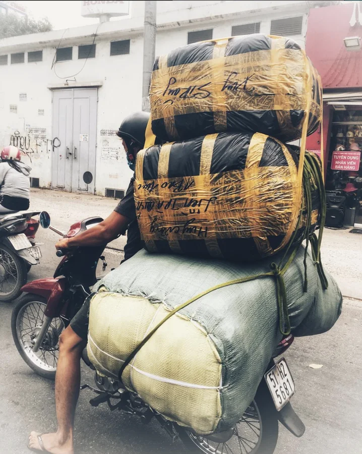 A motorbike loaded with large bundled packages