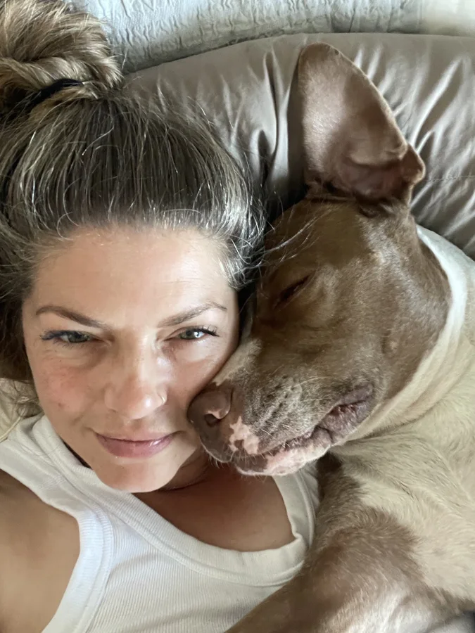 Tony curled up beside a smiling woman